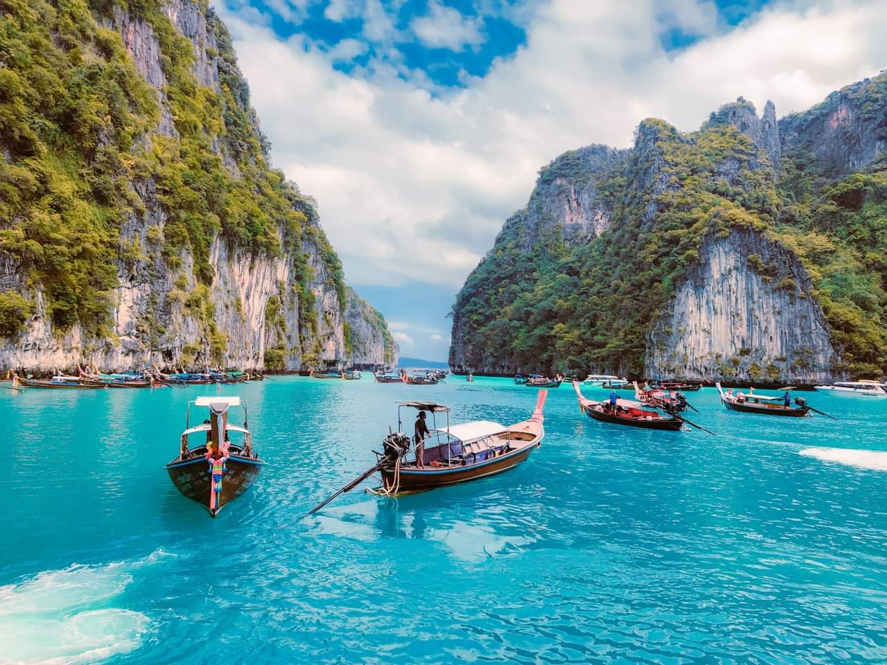 Traditional boats among tropical islands in Thailand