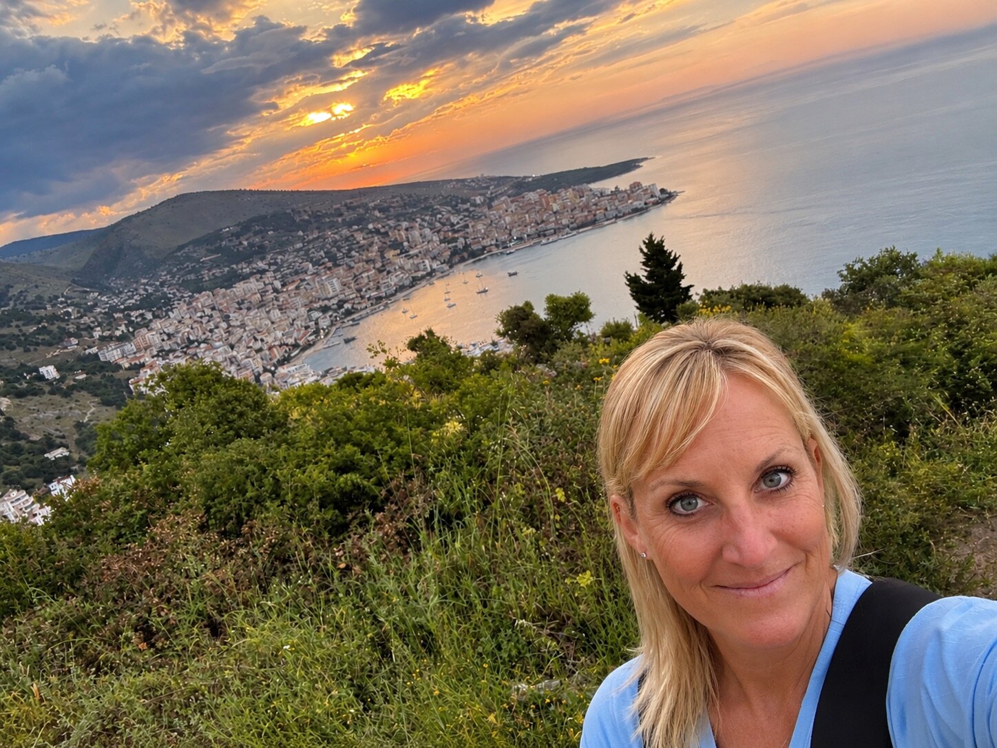 Megan overlooking Sarandë and the Ionian Sea at sunset